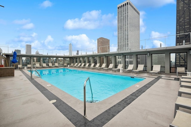 pool with a city view and a patio