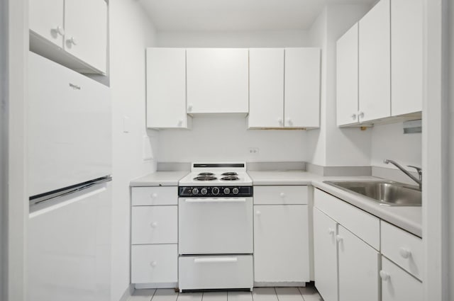 kitchen with white cabinetry, white appliances, light countertops, and a sink