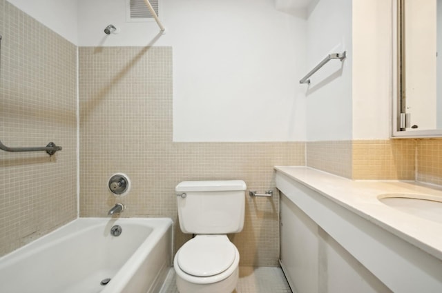 full bathroom with vanity, visible vents, bathtub / shower combination, tile walls, and toilet