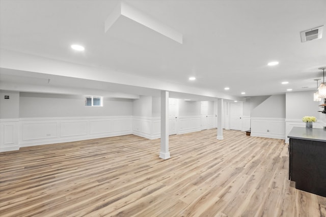 basement with light hardwood / wood-style floors