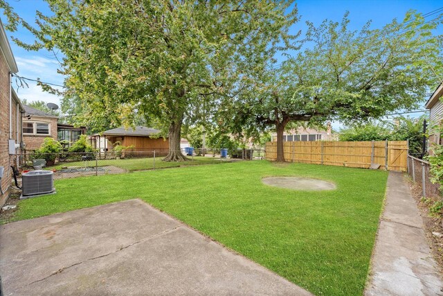 view of yard featuring cooling unit and a patio