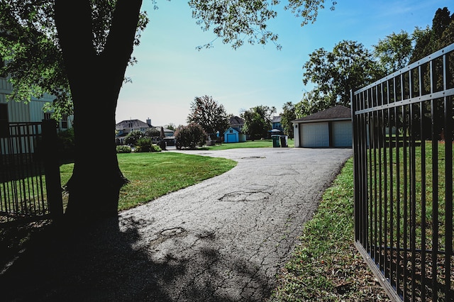 exterior space featuring a garage and an outbuilding