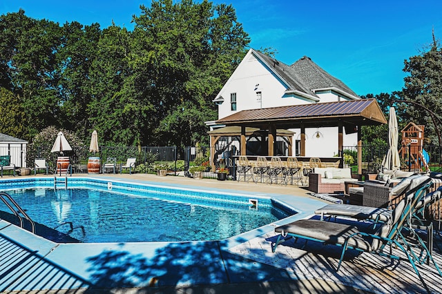 view of pool with a patio area, an outdoor living space, a gazebo, and a playground