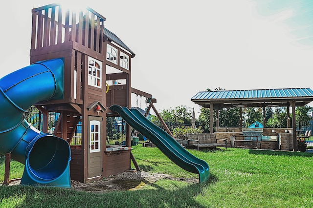 view of playground with a lawn