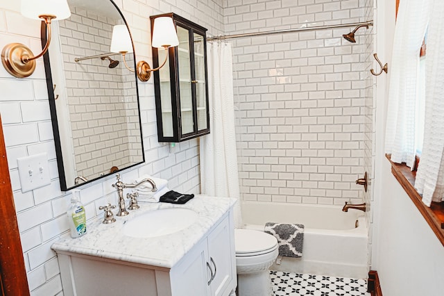 full bathroom with vanity, tile patterned flooring, shower / tub combo, tile walls, and toilet