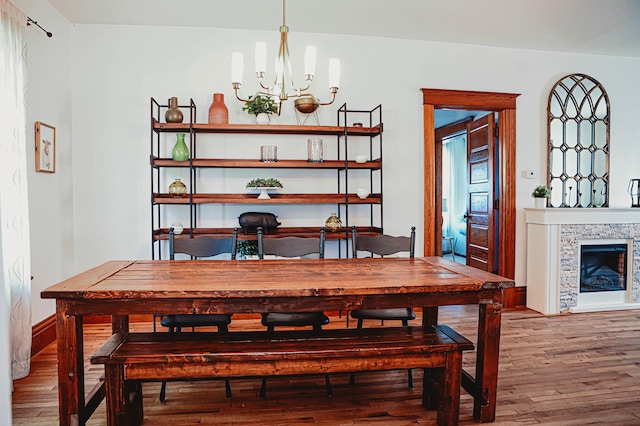 dining space with a notable chandelier and hardwood / wood-style floors