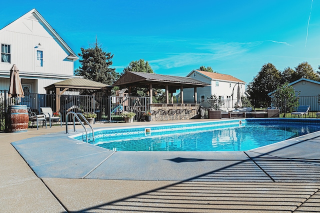 view of swimming pool with a patio and a gazebo