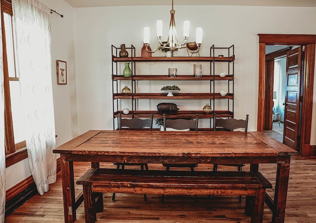 dining area featuring a notable chandelier and hardwood / wood-style flooring