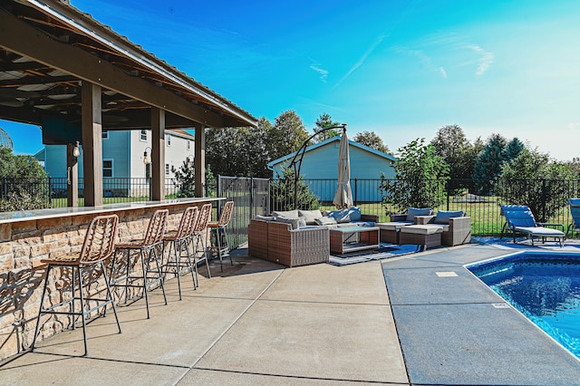 view of patio featuring an outdoor living space, a bar, and a fenced in pool