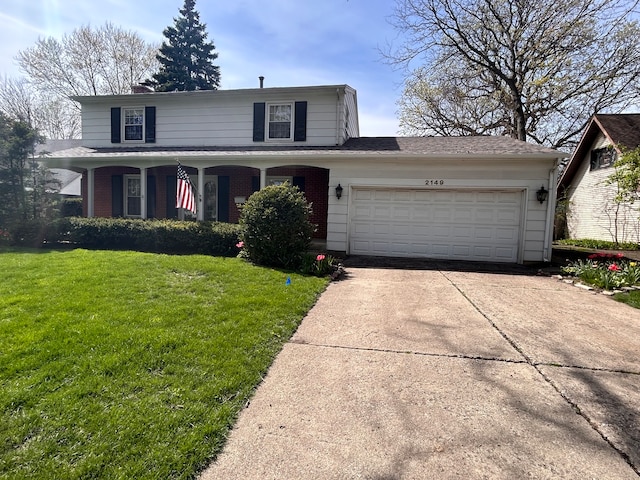 view of front property featuring a garage and a front lawn