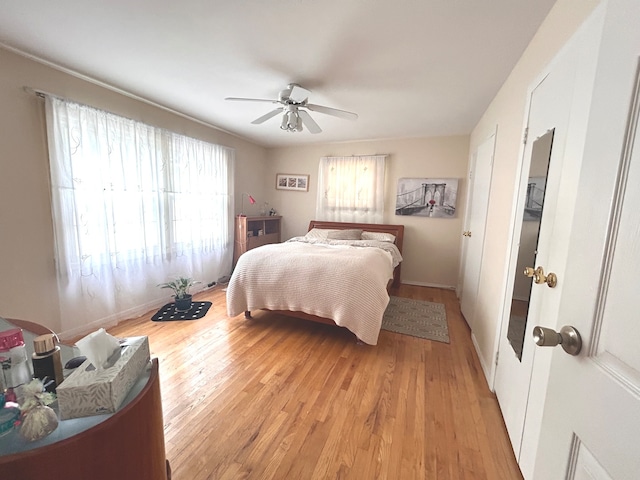 bedroom featuring light wood-type flooring and ceiling fan