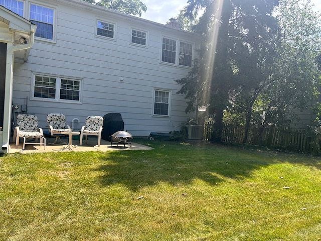 back of house with a lawn, a patio area, and central air condition unit