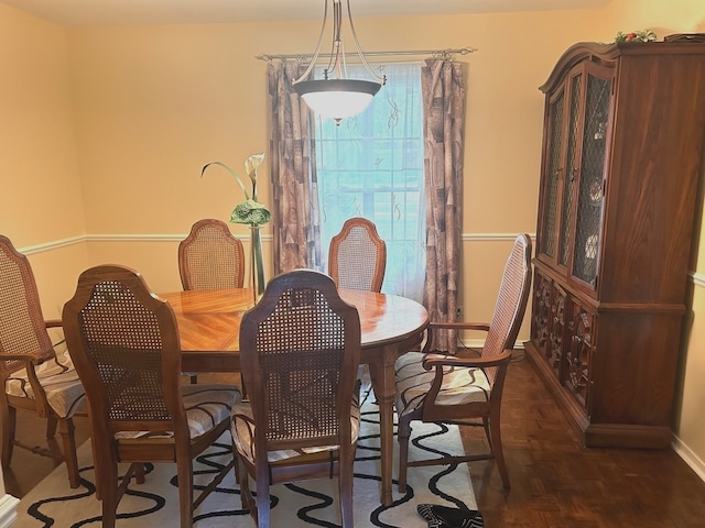 dining area with dark parquet flooring