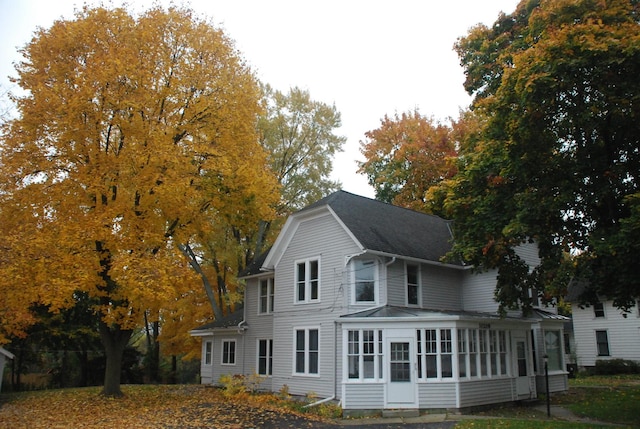 back of property with a sunroom