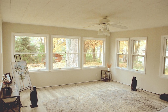 sunroom featuring ceiling fan