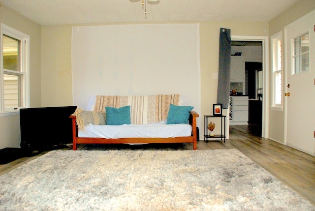 sitting room with wood-type flooring and ceiling fan