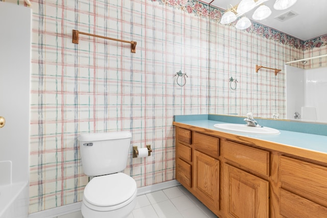 bathroom with toilet, vanity, walk in shower, and tile patterned floors