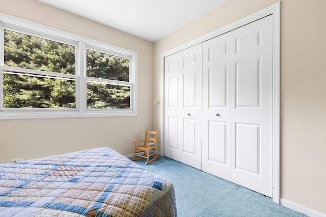 carpeted bedroom with a closet