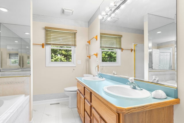 bathroom featuring tiled bath, toilet, tile patterned floors, and vanity