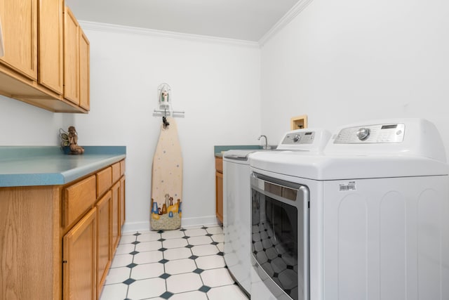 laundry area featuring washing machine and clothes dryer, cabinets, light tile patterned flooring, and ornamental molding