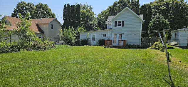 back of property featuring a deck and a yard