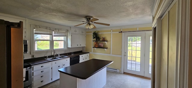 kitchen with ceiling fan, white cabinets, sink, a baseboard heating unit, and stainless steel appliances