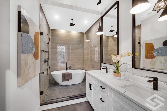 bathroom with tile patterned flooring, shower with separate bathtub, and vanity