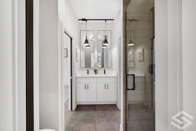 bathroom featuring an enclosed shower and vanity