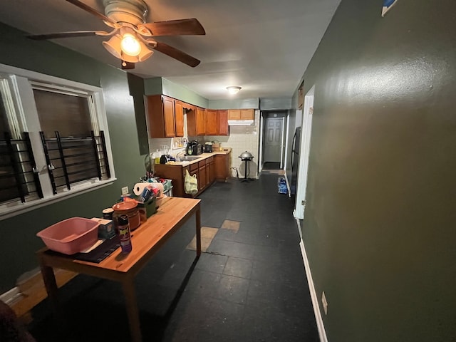 interior space featuring sink and dark tile patterned flooring