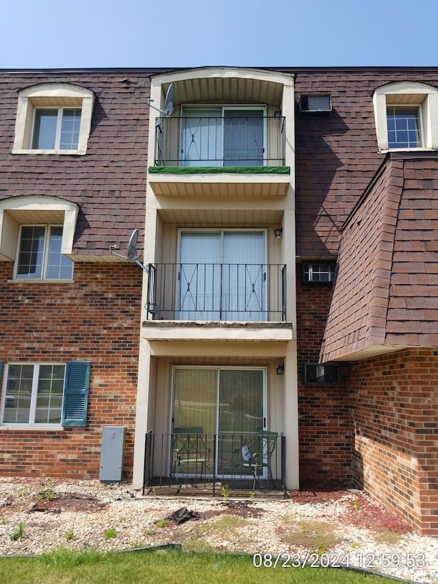 back of property with a balcony