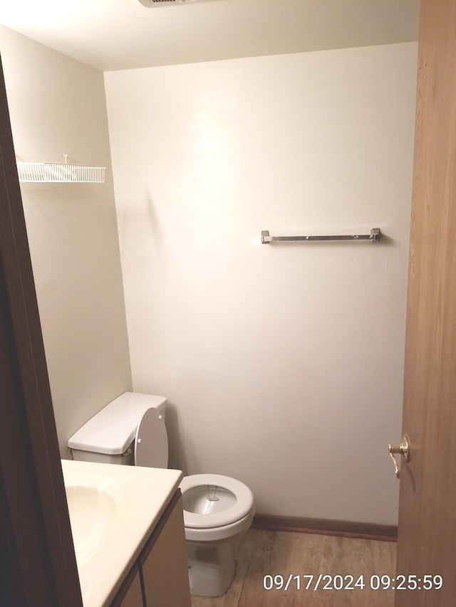 bathroom featuring vanity, toilet, and tile patterned floors