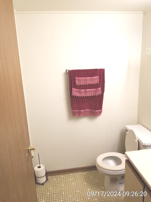 bathroom with tile patterned flooring, vanity, and toilet