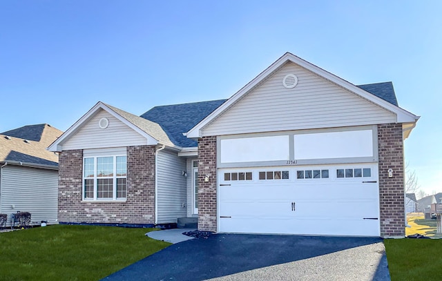 view of front of home with a front yard and a garage