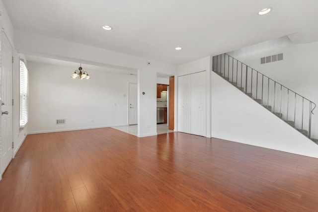 1781 Queensbury Cir, Hoffman Estates, IL 60169 - unfurnished living room featuring a chandelier, stairway, light wood finished floors, and recessed lighting