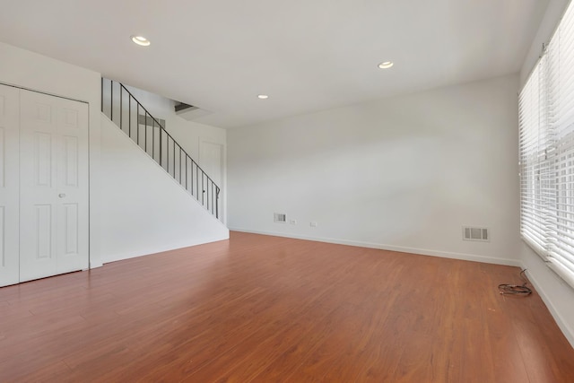 1781 Queensbury Cir, Hoffman Estates, IL 60169 - unfurnished living room with stairs, plenty of natural light, wood finished floors, and recessed lighting