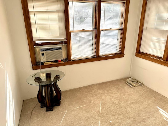 unfurnished room with cooling unit and light carpet