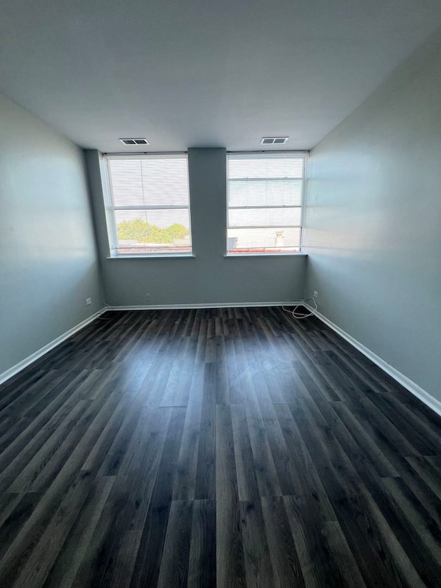 empty room with dark hardwood / wood-style floors