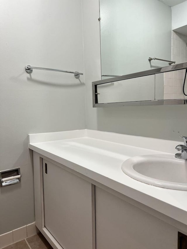 bathroom featuring vanity, baseboards, and tile patterned floors