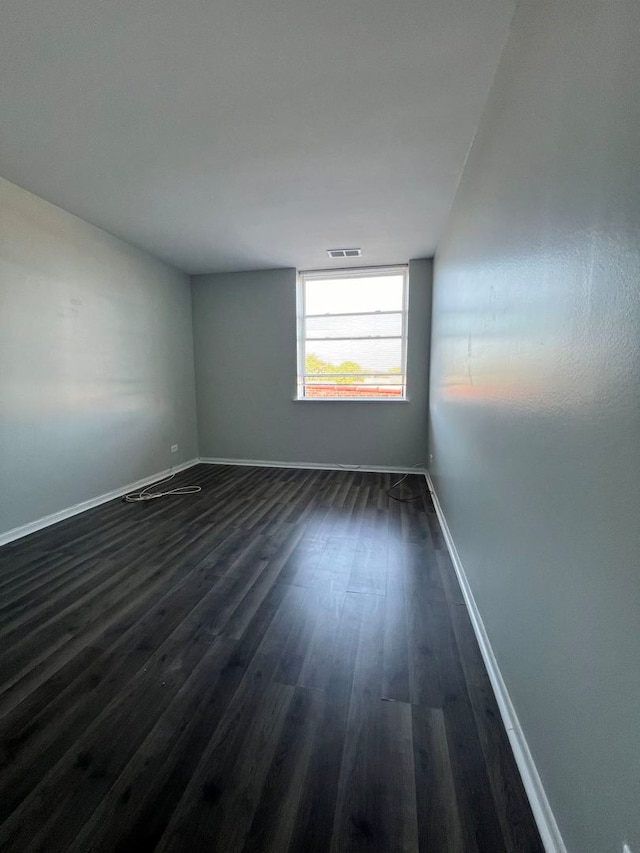 spare room featuring dark hardwood / wood-style flooring