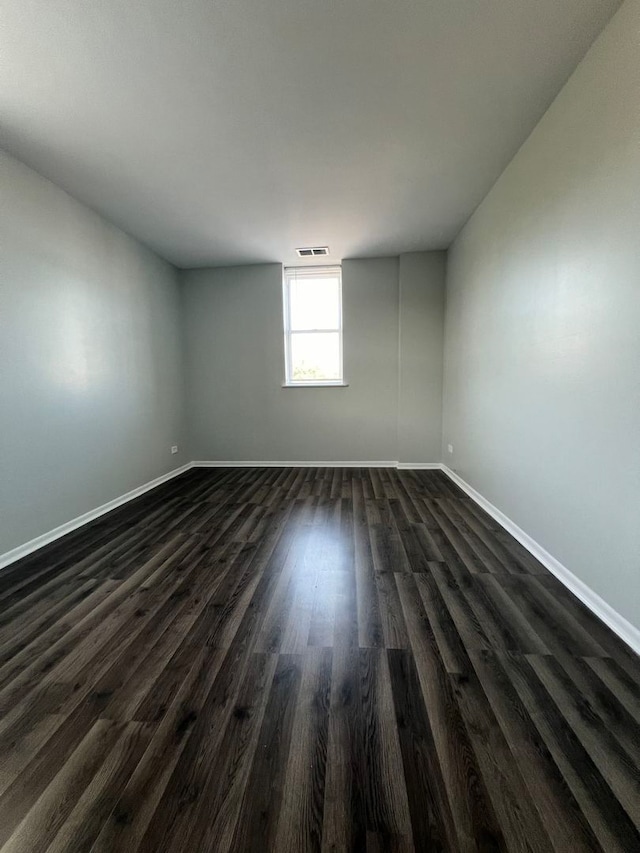 spare room featuring dark hardwood / wood-style floors