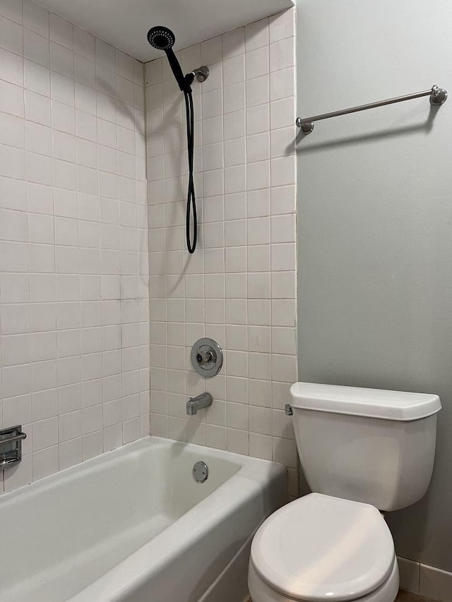 bathroom with toilet and bathing tub / shower combination