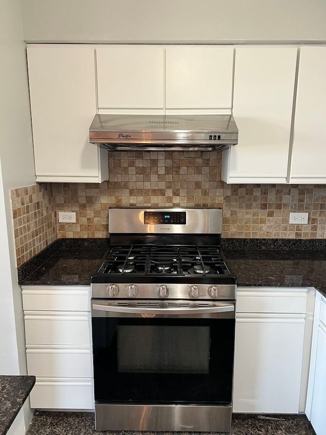 kitchen with wall chimney exhaust hood, tasteful backsplash, stainless steel gas stove, and white cabinets