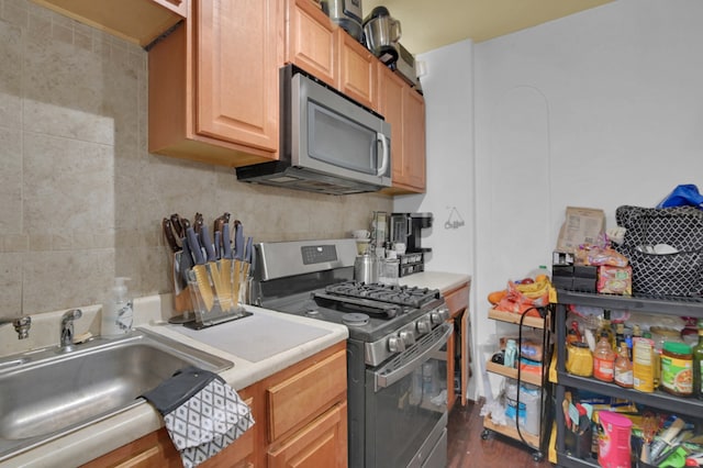 kitchen with dark wood-type flooring, stainless steel appliances, and sink