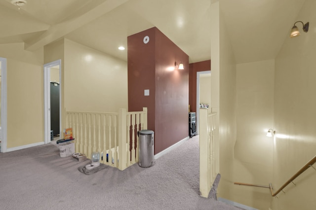 hallway featuring carpet and lofted ceiling with beams