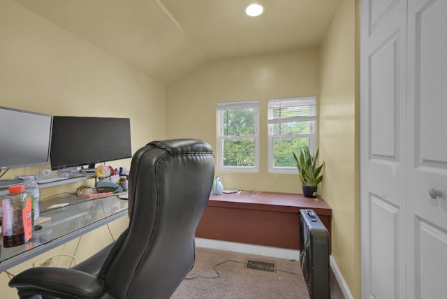 carpeted office featuring lofted ceiling