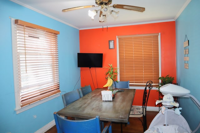 dining space featuring ceiling fan, hardwood / wood-style flooring, and crown molding