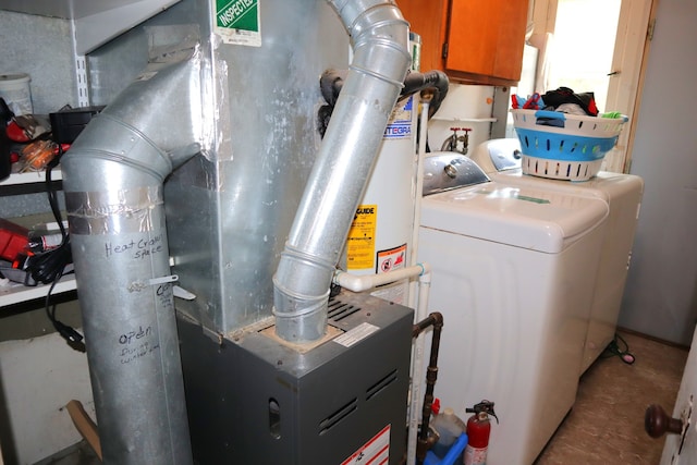 utility room featuring washer and dryer and heating unit