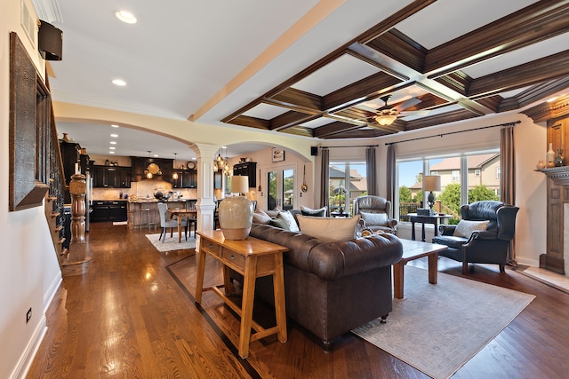 living room featuring coffered ceiling, decorative columns, and dark hardwood / wood-style floors