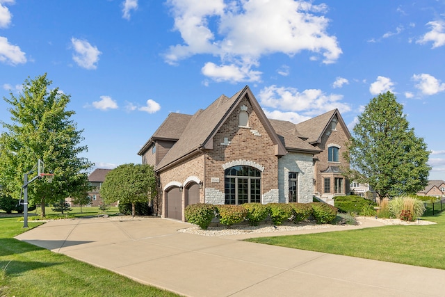 view of front of home with a garage and a front lawn