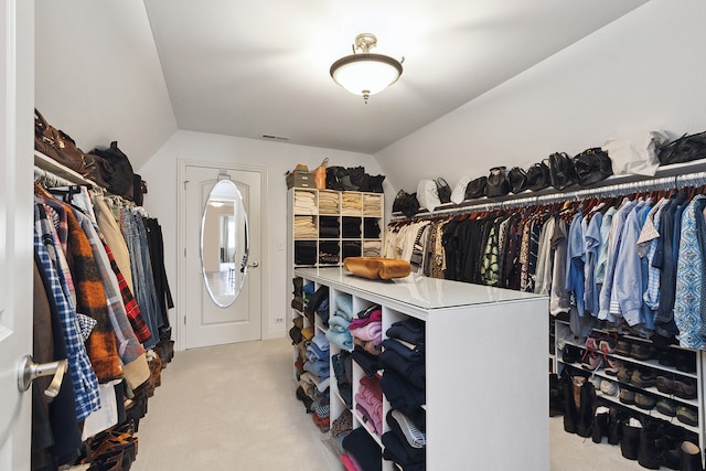 spacious closet with light carpet and lofted ceiling